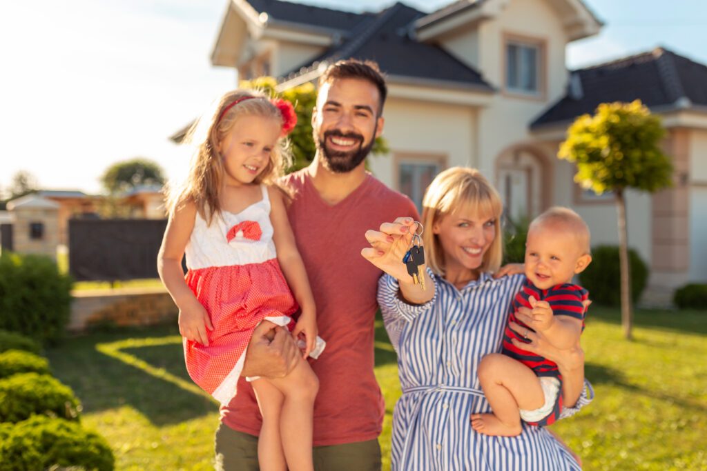 Family holding keys after buying house Family holding keys after buying house