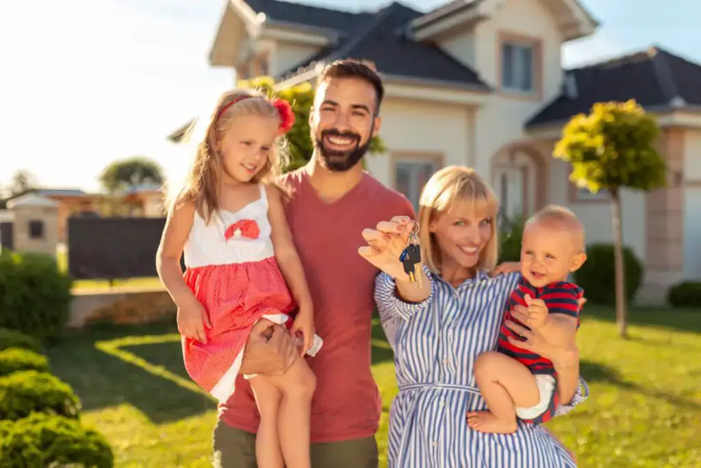 Family holding keys after buying house